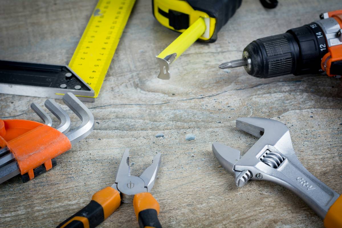 tools for diy heat gun: professional-grade heat gun with nozzles and safety gear laid out on workbench